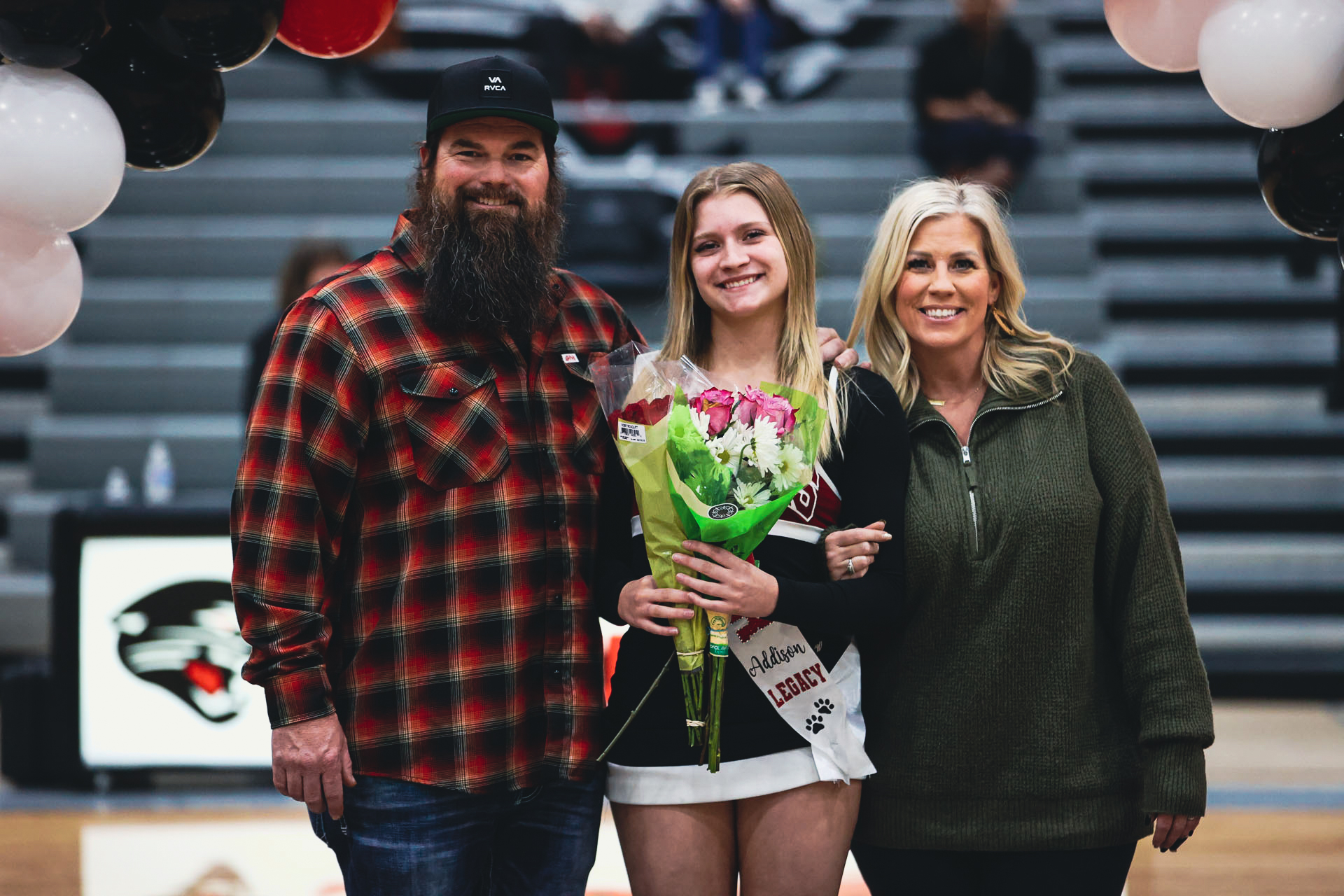 Addi with her family smiling for the camera